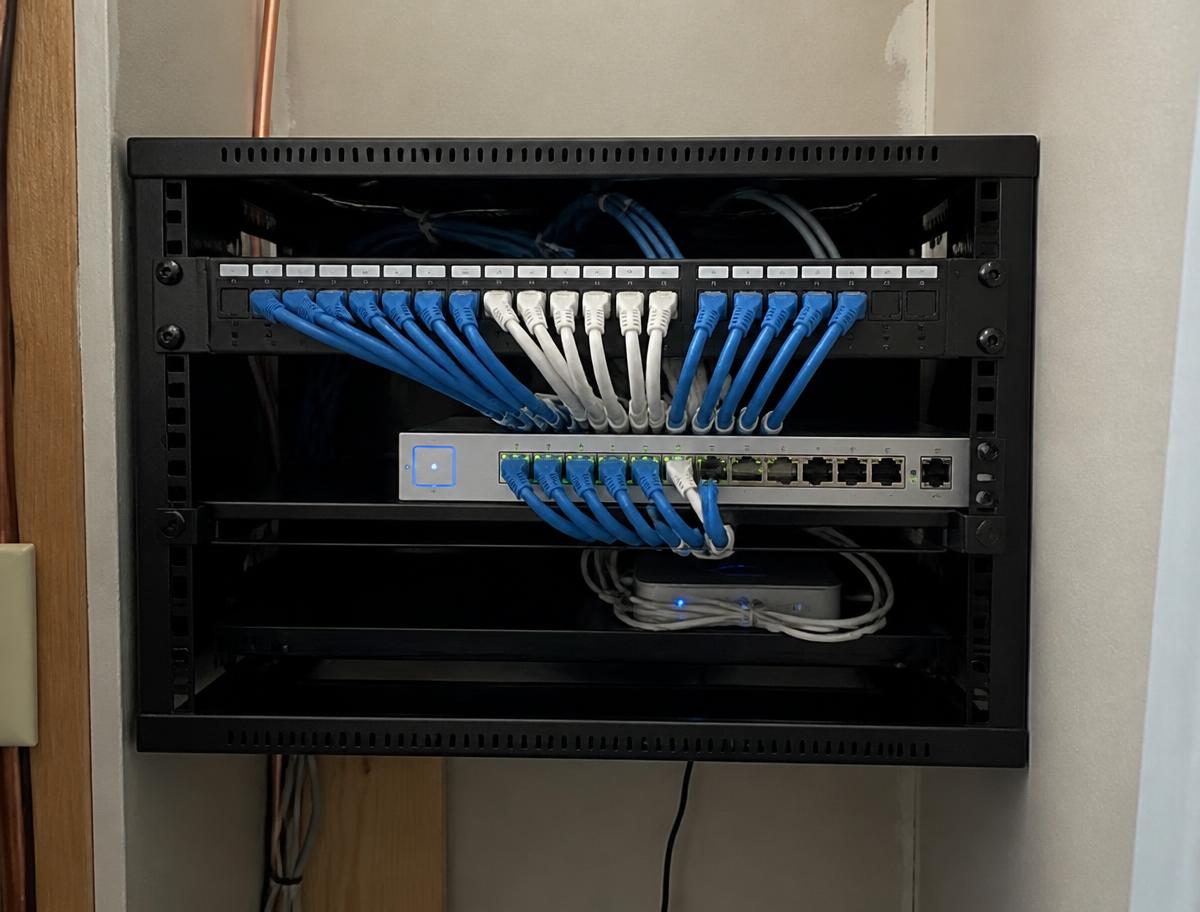 Wall-mounted home network panel with neatly terminated Ethernet cabling